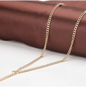 Close-up of polished gold metal link chain with high-gloss finish for women's outfits