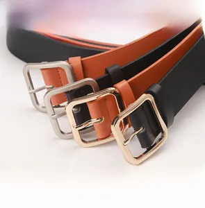Detail view of stylish faux leather waist belts with square metal buckles in gold and silver