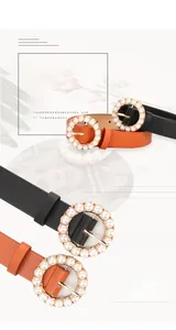 Detailed macro view of smooth leather belts featuring round buckles with pearl embellishments