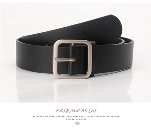 Close-up of a minimalist black leather belt with a square silver buckle for women