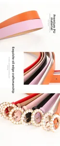 Close-up of pearl round buckle detail and fine stitching on colorful women belt