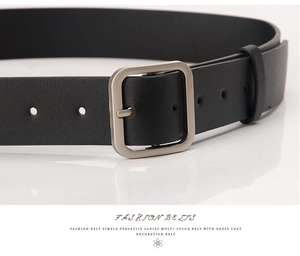 Close-up of women's black faux leather belt with matte silver square buckle and neat holes