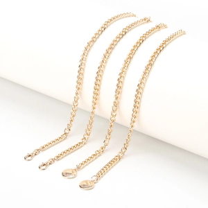 Chic gold waist chain belt for women with decorative charms and lobster clasps on white background