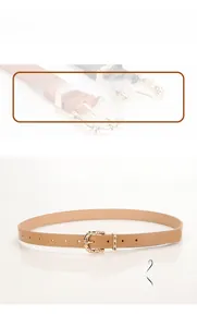 Detail of khaki PU leather belt with decorative gold buckle and adjustment holes