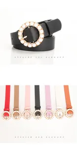 Close-up of elegant women belt featuring round gold buckle with inlaid pearls in 7 colors