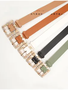 Close-up of women's PU leather belts in five colors with sparkling rhinestone buckles