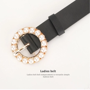 Elegant women's black leather belt featuring a round gold buckle with pearl embellishments