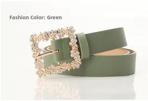 Detail of green PU leather belt with gold rose buckle and rhinestone inlay for dresses