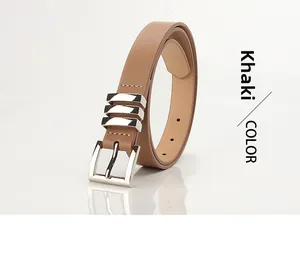 Detail of khaki leather belt with silver polished buckle and metal decorative rings
