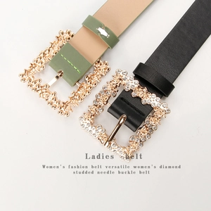 Detail of rhinestone-encrusted gold alloy buckle on elegant olive green and black leather belts