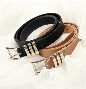 Detail of stylish women's belts in black and khaki with silver square buckles on lace