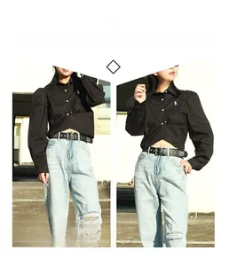 Punk black leather belt with silver pyramid studs on light blue ripped jeans