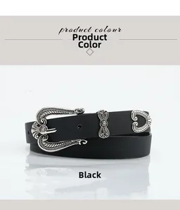 Detailed view of vintage silver engraved crown buckle and tip on a black western belt