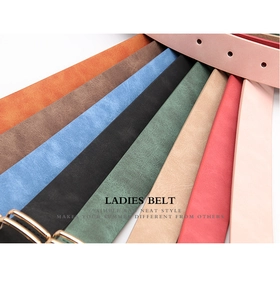 Flat lay of colorful women's leather belts with golden alloy buckles in various vibrant shades