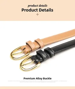 Close-up of elegant black and brown leather belts with gold oval alloy buckles