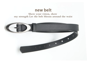Detail of minimalist black leather belt featuring an oval vintage silver alloy buckle
