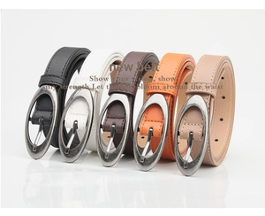 Close-up of assorted women's skinny belts with oval alloy buckles and retro sandblasted finish