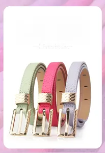 Detailed view of candy-colored leather belts in green, pink, and purple with gold buckles