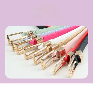 Close-up of colorful PU leather belts with decorative gold alloy buckles and lychee texture