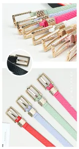 Close-up of candy color leather belts showing luxury gold hollow buckle and texture