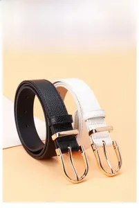 Close-up of slim leather belts with golden bamboo-style U-buckles in black and white