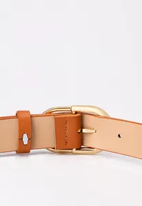 Detail of premium solid alloy gold buckle and brown leather texture for a women belt