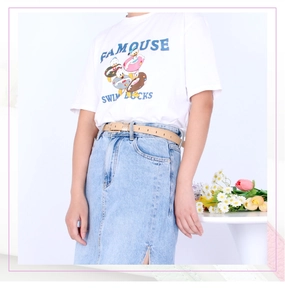 Close-up of slim khaki leather belt paired with a white t-shirt and denim skirt