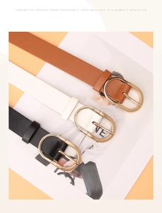 Detailed view of women's PU leather belts in brown, white, and black with gold buckles