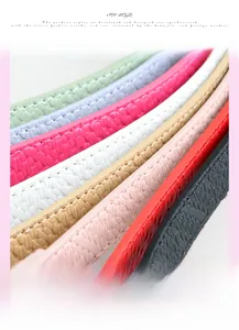 Detail view of multi-color slim leather belts with pebble texture and matching stitching