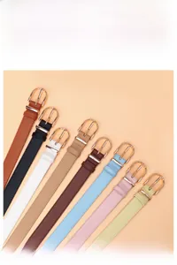 Selection of narrow leather belts for women with round gold buckles in eight vibrant colors