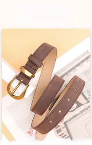 Detailed macro view of vintage brown matte leather belt with antique golden alloy buckle