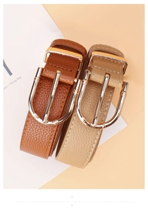 Detailed view of brown and beige lychee pattern leather belts with gold bamboo U-buckles