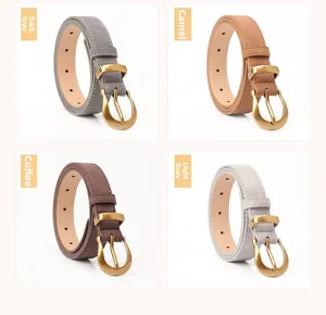 Detailed view of four retro thin leather belts with white stitching and matte gold D-rings