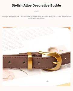 Detail of vintage gold alloy buckle on a dark brown leather belt for women's jeans