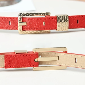 Red pebbled leather belt for women with elegant golden engraved buckle and metal loop
