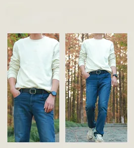Close-up of minimalist black leather belt with silver pin buckle on blue denim jeans
