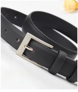Close-up of classic black leather belt featuring a polished rectangular silver pin buckle