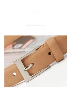 Detail of light brown leather belt with silver square alloy buckle and litchi texture
