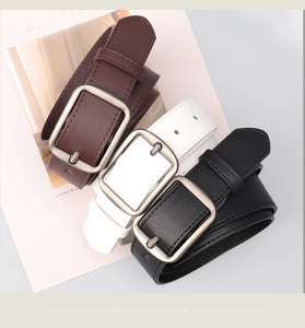 Close-up of rectangular alloy pin buckles and leather texture in black, brown and white