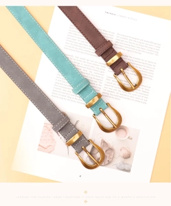 Detailed view of vintage thin leather belts with gold D-buckles in brown, blue and grey