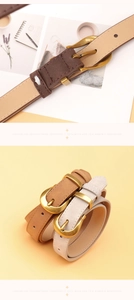 Detail of round golden buckles and smooth leather texture on brown and beige belts