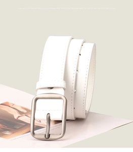 Detailed close-up of a minimalist white leather belt featuring a silver matte pin buckle