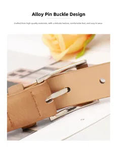 Detailed close-up of light brown leather belt with silver pin buckle and fine texture