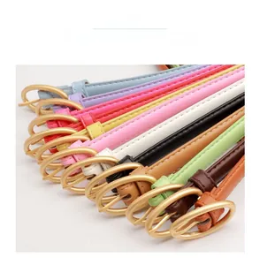 Colorful slim leather belts for women with round golden buckles in multiple vibrant shades
