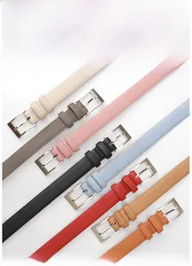Detailed flat lay of slim faux leather belts with silver buckles in various colors