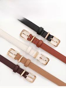 Detail view of four elegant skinny leather belts in black, brown, cream, and tan colors