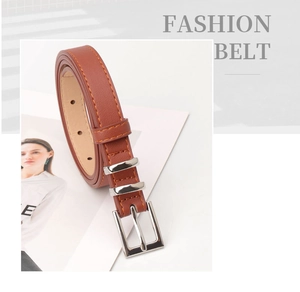 Detailed macro view of the brown faux leather belt with silver buckle and fine stitching