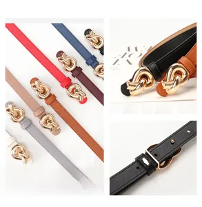 Detail showing various colors of slim leather belts for women with golden knot buckle