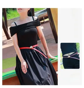 Detail of elegant knot-shaped alloy buckle on a slim waist belt for dresses