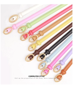 Collection of colorful slim leather belts for women with elegant oval gold buckles